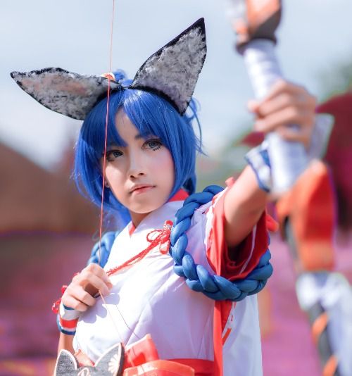 girl in blue and red long sleeve shirt holding a umbrella